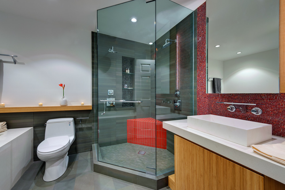 Small modern 3/4 bathroom in San Francisco with mosaic tile, a vessel sink, red tile, open cabinets, a two-piece toilet, white walls, a hinged shower door, light wood cabinets, a corner shower, porcelain floors, engineered quartz benchtops and grey floor.