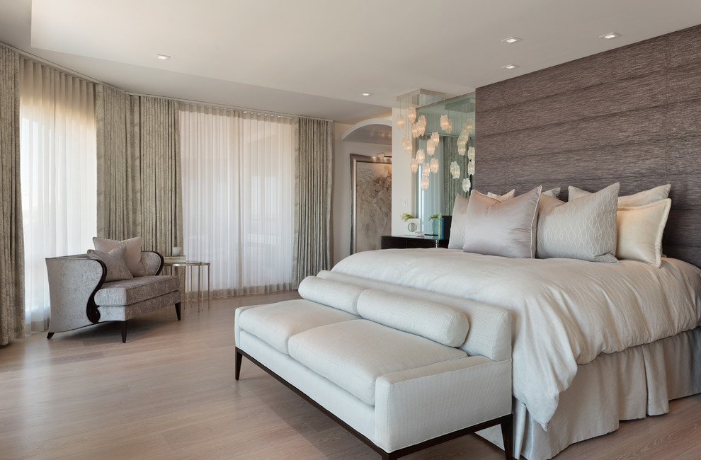 This is an example of a contemporary master bedroom in Miami with light hardwood floors and beige floor.