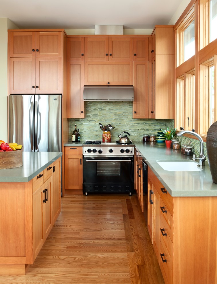 Photo of a mid-sized transitional l-shaped eat-in kitchen in San Francisco with shaker cabinets, medium wood cabinets, green splashback, matchstick tile splashback, stainless steel appliances, an undermount sink, quartz benchtops, medium hardwood floors and with island.