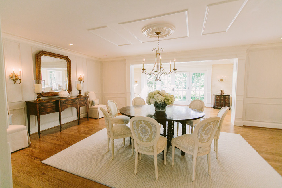 This is an example of a large traditional open plan dining in Baltimore with white walls, light hardwood floors and no fireplace.