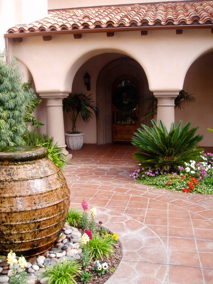 This is an example of a mediterranean courtyard patio in San Diego with tile.