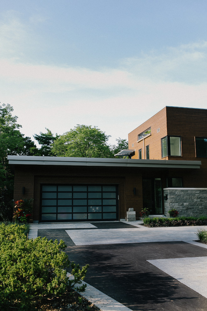 Design ideas for a large midcentury front yard full sun driveway for summer in Toronto with concrete pavers.