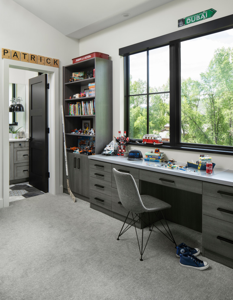This is an example of a country kids' bedroom for boys in Denver with white walls, carpet, grey floor and vaulted.