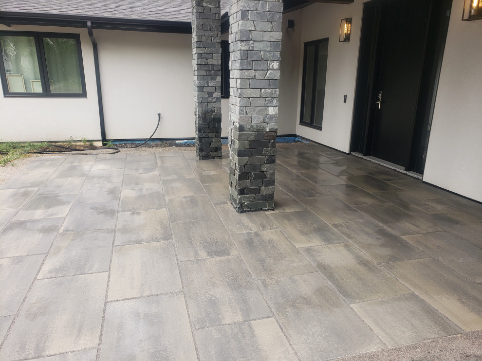 Photo of a large rustic partial sun front yard concrete paver landscaping in Edmonton for summer.
