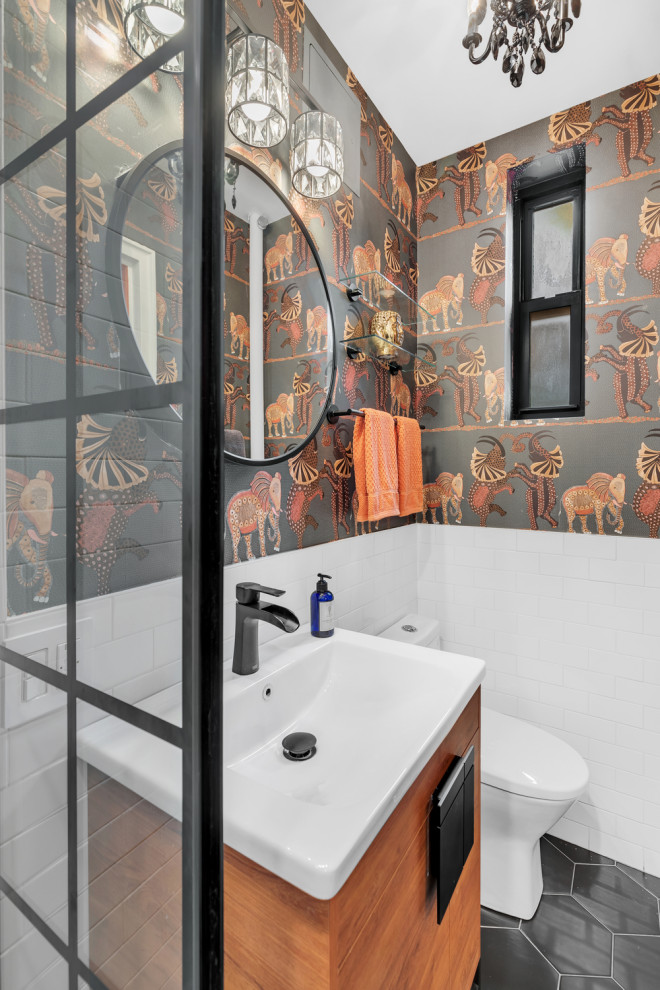 Photo of a mid-sized traditional master bathroom in New York with flat-panel cabinets, brown cabinets, an alcove shower, multi-coloured tile, ceramic tile, ceramic floors, quartzite benchtops, black floor, a hinged shower door, white benchtops, a single vanity, a floating vanity and wallpaper.