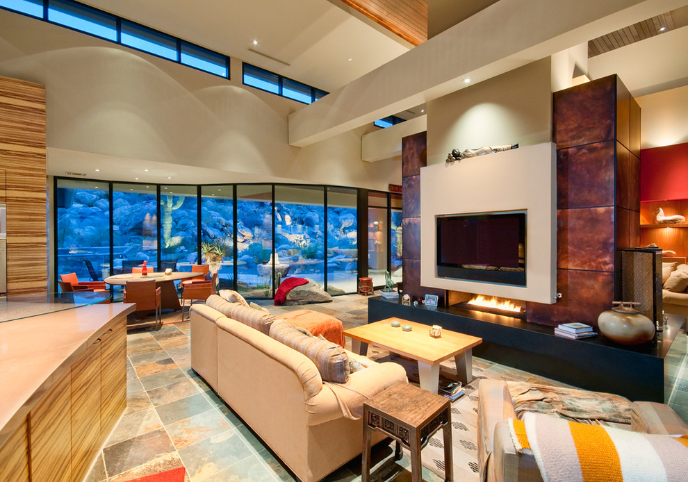 Large open concept living room in Phoenix with a two-sided fireplace, a wall-mounted tv and porcelain floors.