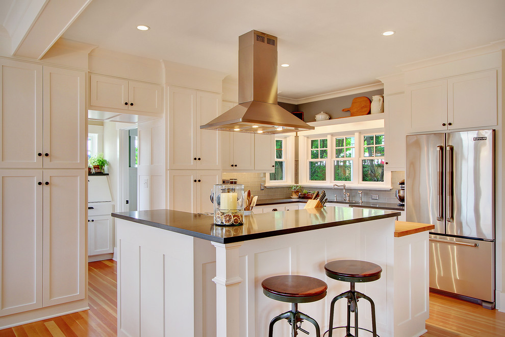This is an example of a traditional kitchen in Seattle with shaker cabinets, stainless steel appliances and white cabinets.