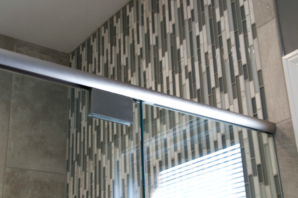Inspiration for a mid-sized transitional master gray tile and ceramic tile ceramic tile walk-in shower remodel with an undermount sink, raised-panel cabinets, white cabinets, granite countertops, a two-piece toilet and gray walls