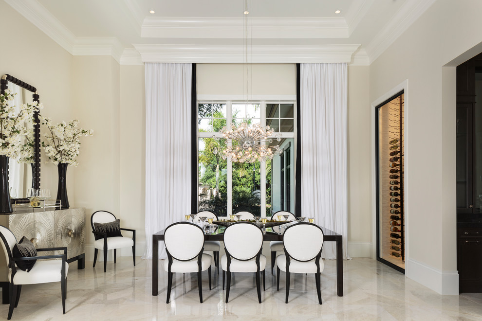 Design ideas for a transitional dining room in Miami with beige walls and beige floor.