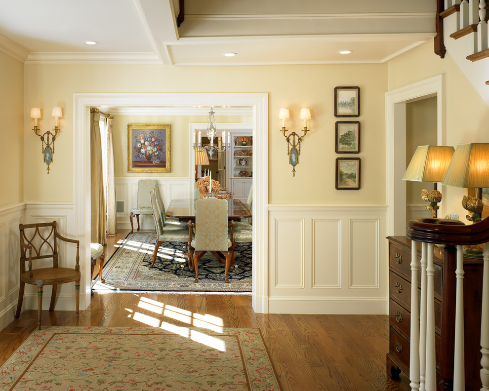 Photo of a mid-sized traditional foyer in Boston with yellow walls and light hardwood floors.