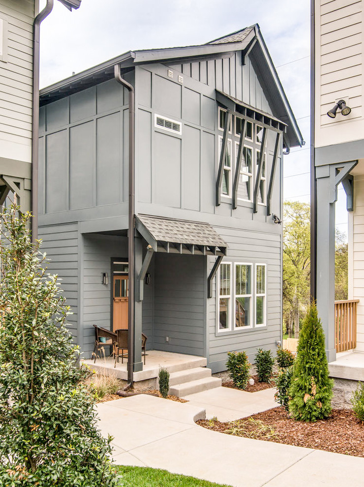 Photo of a mid-sized contemporary two-storey blue exterior in Nashville with mixed siding.