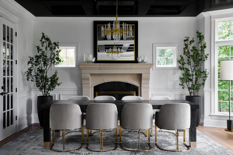 Inspiration for a transitional light wood floor, beige floor and wainscoting dining room remodel in Chicago with white walls and a standard fireplace