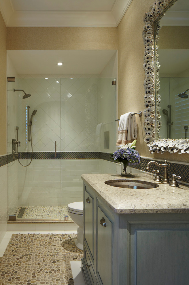 This is an example of a mid-sized country bathroom in Miami with raised-panel cabinets, green cabinets, white tile, ceramic tile, beige walls, pebble tile floors, an undermount sink, granite benchtops, brown floor and brown benchtops.