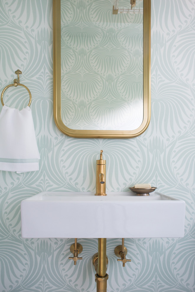 Inspiration for a small transitional powder room in Boston with shaker cabinets, white cabinets, a wall-mount toilet, white tile, stone tile, white walls, mosaic tile floors, an undermount sink, marble benchtops and white floor.
