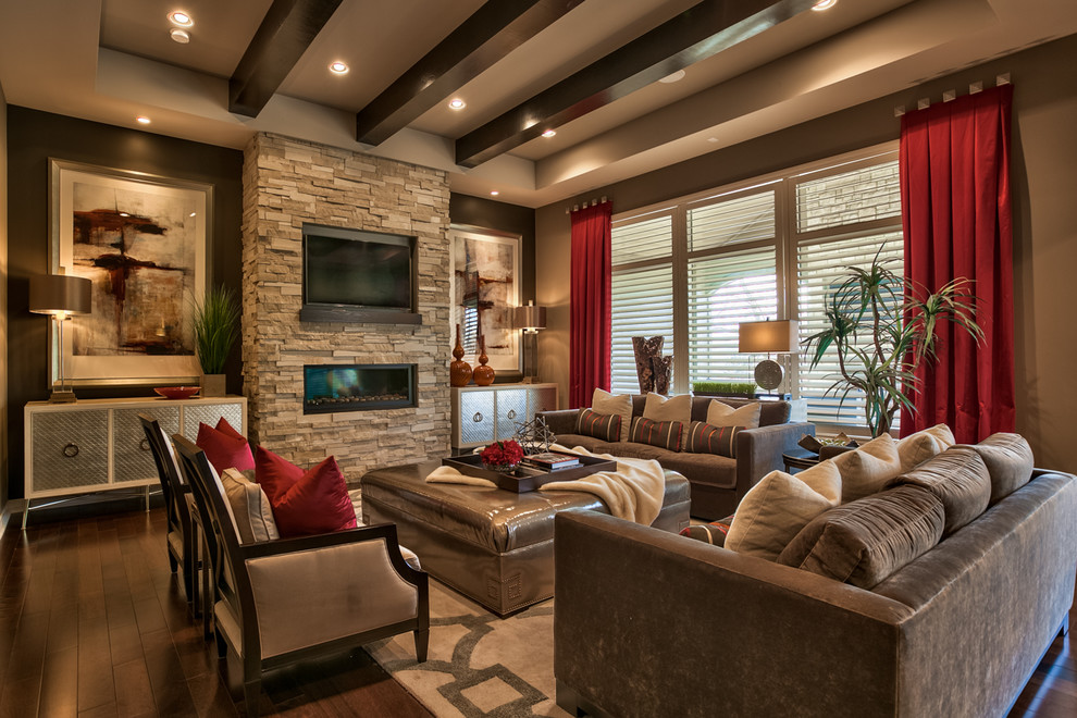 This is an example of a transitional formal open concept living room in Omaha with brown walls, dark hardwood floors, a ribbon fireplace, a stone fireplace surround, a wall-mounted tv and brown floor.
