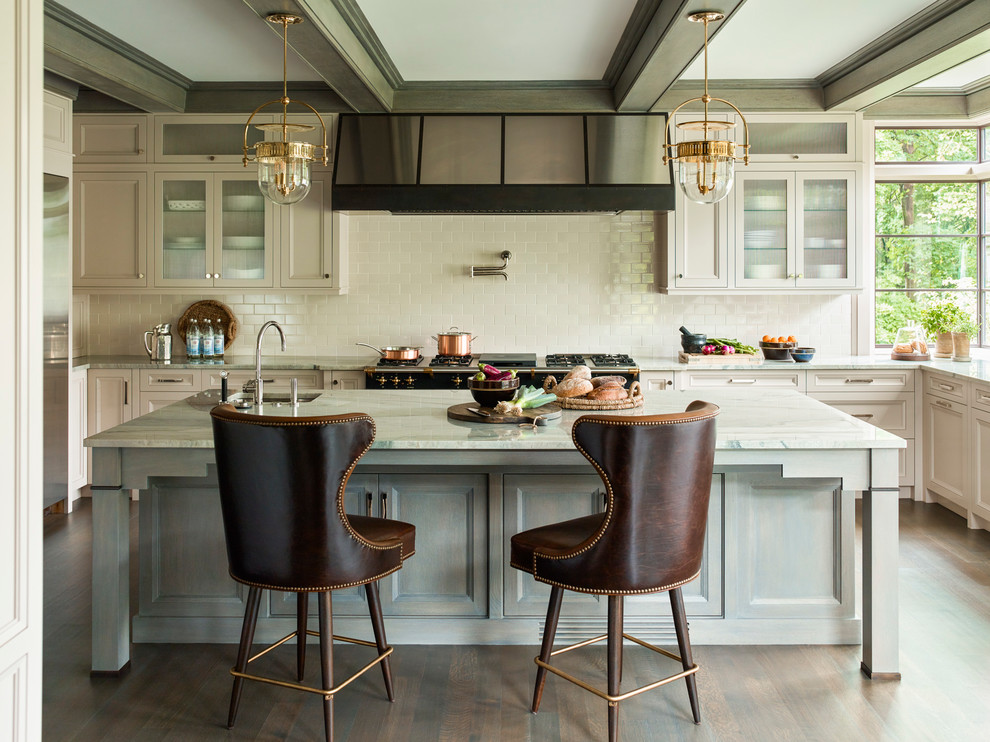 Design ideas for a large transitional l-shaped kitchen in Boston with beige cabinets, marble benchtops, beige splashback, subway tile splashback, black appliances, with island, brown floor, green benchtop, recessed-panel cabinets and dark hardwood floors.