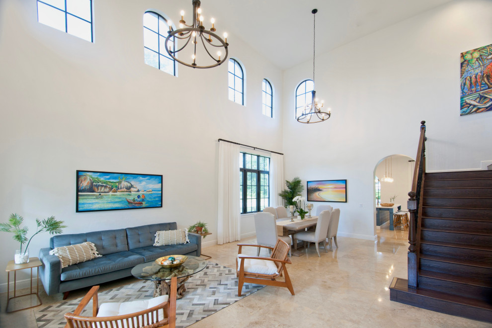 This is an example of a medium sized nautical open plan living room in Miami with white walls, travertine flooring and beige floors.
