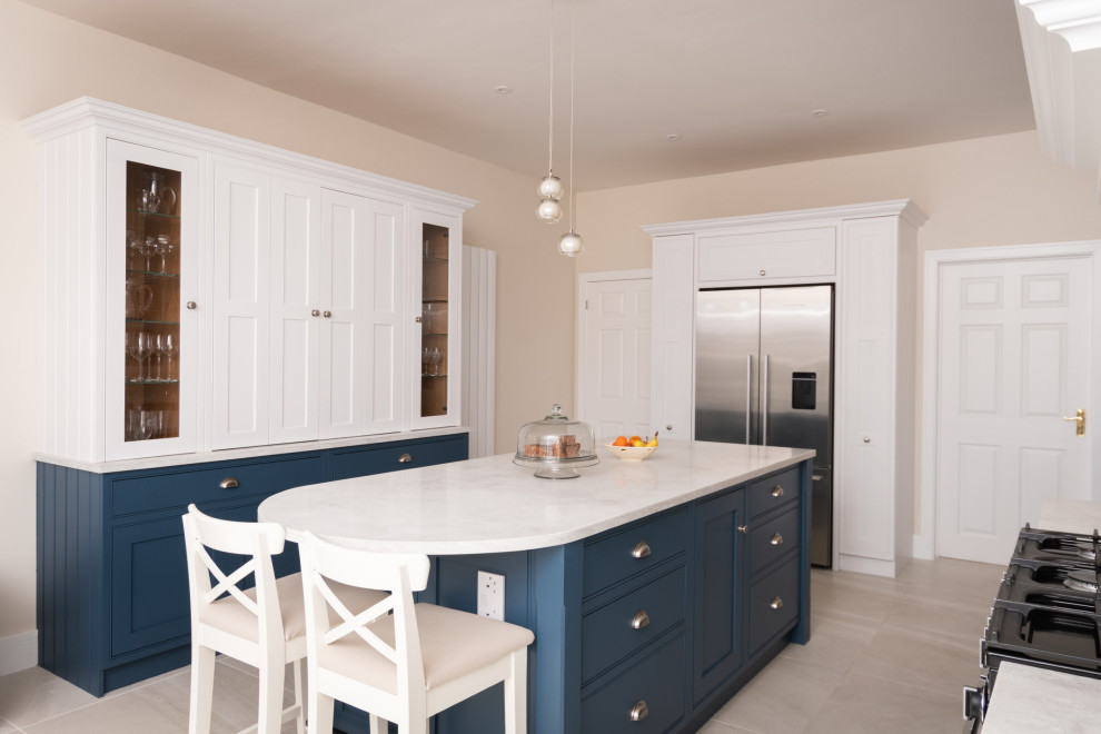 Inspiration for a large contemporary galley open plan kitchen in Essex with a farmhouse sink, recessed-panel cabinets, medium wood cabinets, quartzite benchtops, grey splashback, engineered quartz splashback, black appliances, concrete floors, with island, grey floor and grey benchtop.