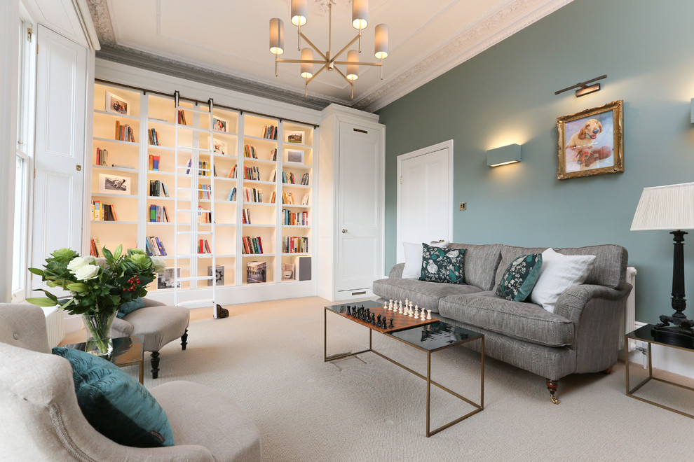 Design ideas for a transitional home office in London with a library, green walls, carpet and beige floor.