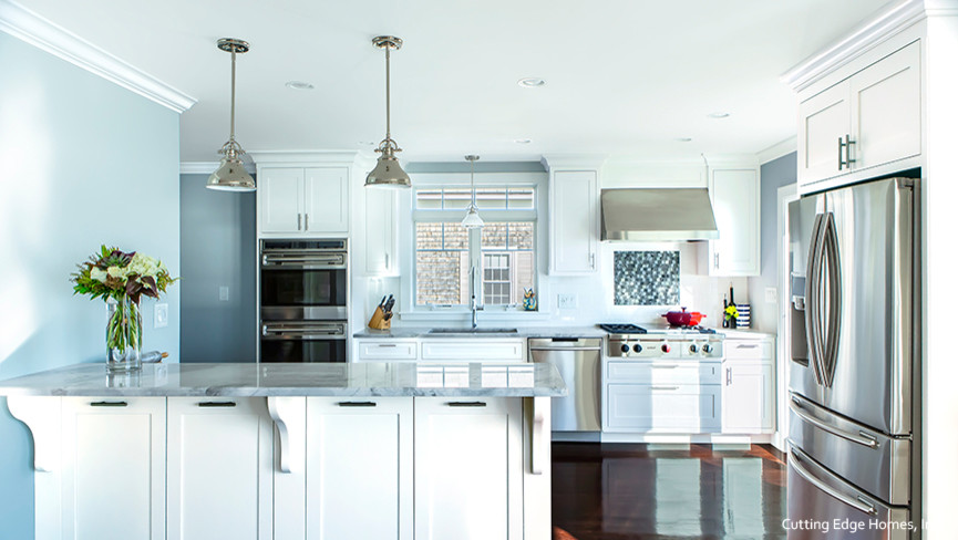 Large beach style u-shaped eat-in kitchen in Boston with an undermount sink, flat-panel cabinets, white cabinets, marble benchtops, blue splashback, stainless steel appliances and dark hardwood floors.