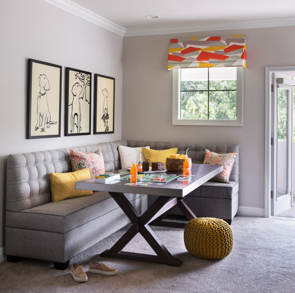 Dog Time Playroom - For a canine loving family, a dog themed playroom was the logical choice.  With two boys and a girl, the gender neutral theme works for all of the kids.  The large stainless steel table and tufted banquette provide a place for snacks and family game night.  Decorative awnings were created with a colorful abstracted fabric in orange, yellow, white, and lavender.  Double doors open to a covered second floor porch overlooking a green space.