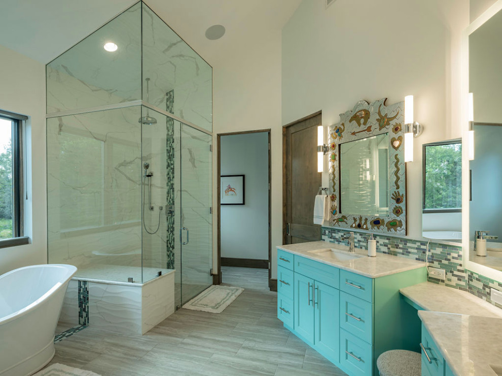 Design ideas for a contemporary master bathroom in Other with flat-panel cabinets, green cabinets, a freestanding tub, a curbless shower, a two-piece toilet, multi-coloured tile, glass tile, white walls, porcelain floors, an undermount sink, onyx benchtops, grey floor and white benchtops.