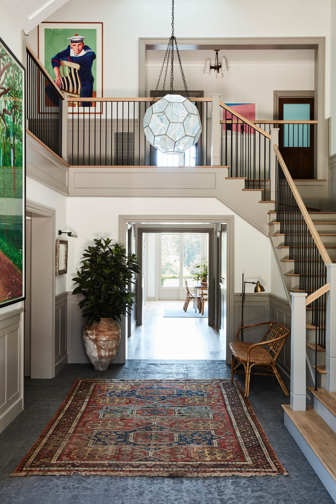 Inspiration for a mid-sized beach style entryway in Los Angeles with limestone floors and grey floor.