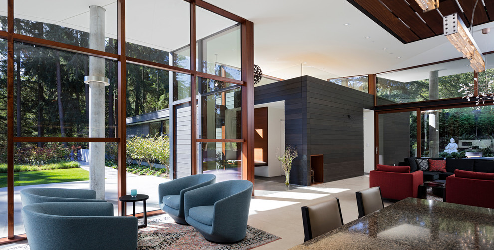 Modern living room in Seattle with porcelain floors, a two-sided fireplace and a metal fireplace surround.
