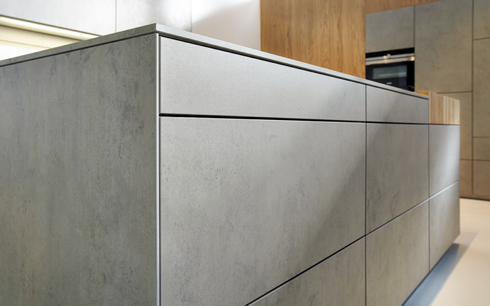 Inspiration for a contemporary open plan kitchen in Nuremberg with grey cabinets, a breakfast bar and grey worktops.
