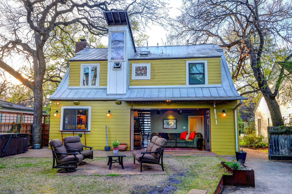 Inspiration for an eclectic two-storey green exterior in Austin.
