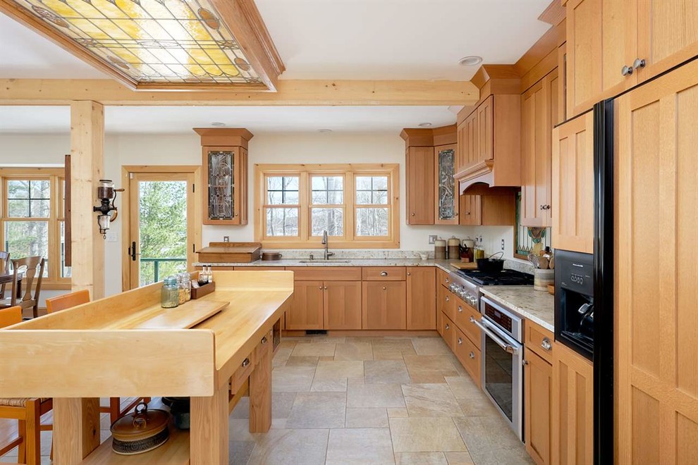 Photo of an arts and crafts l-shaped kitchen in Portland Maine with an undermount sink, shaker cabinets, medium wood cabinets, with island, multi-coloured floor, multi-coloured benchtop and panelled appliances.
