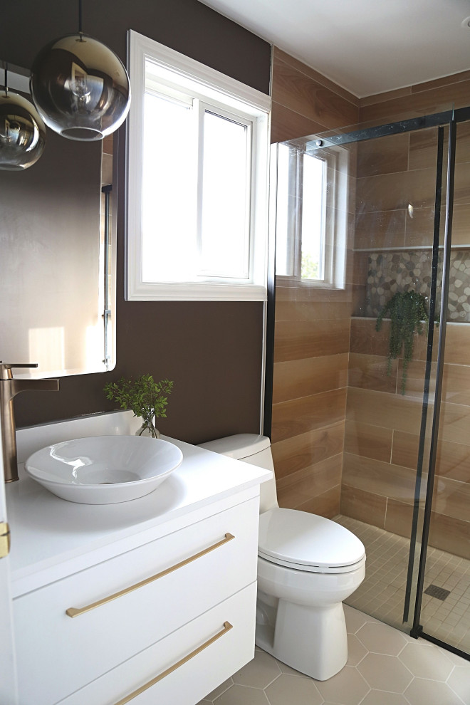 Photo of a small contemporary ensuite bathroom in Toronto with flat-panel cabinets, white cabinets, a built-in shower, a two-piece toilet, brown tiles, wood-effect tiles, brown walls, porcelain flooring, a vessel sink, engineered stone worktops, beige floors, a sliding door, white worktops, a single sink and a floating vanity unit.