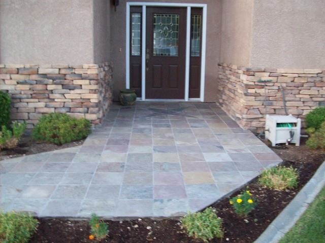 This is an example of a mid-sized mediterranean front door in Milwaukee with beige walls, slate floors, a single front door and a brown front door.