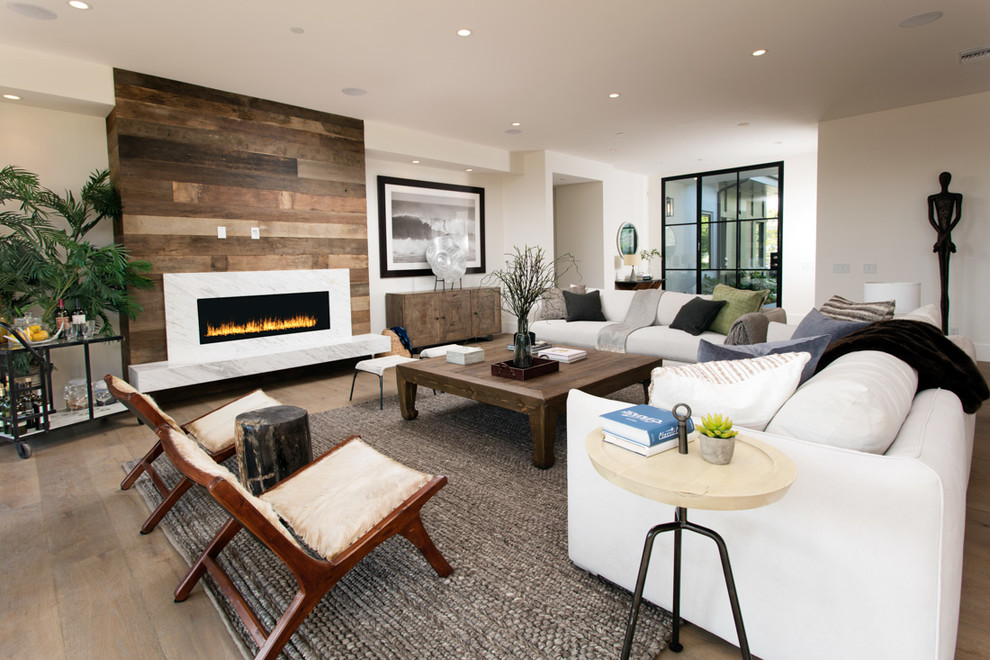 Inspiration for a contemporary formal open concept living room in Los Angeles with white walls, medium hardwood floors and a ribbon fireplace.
