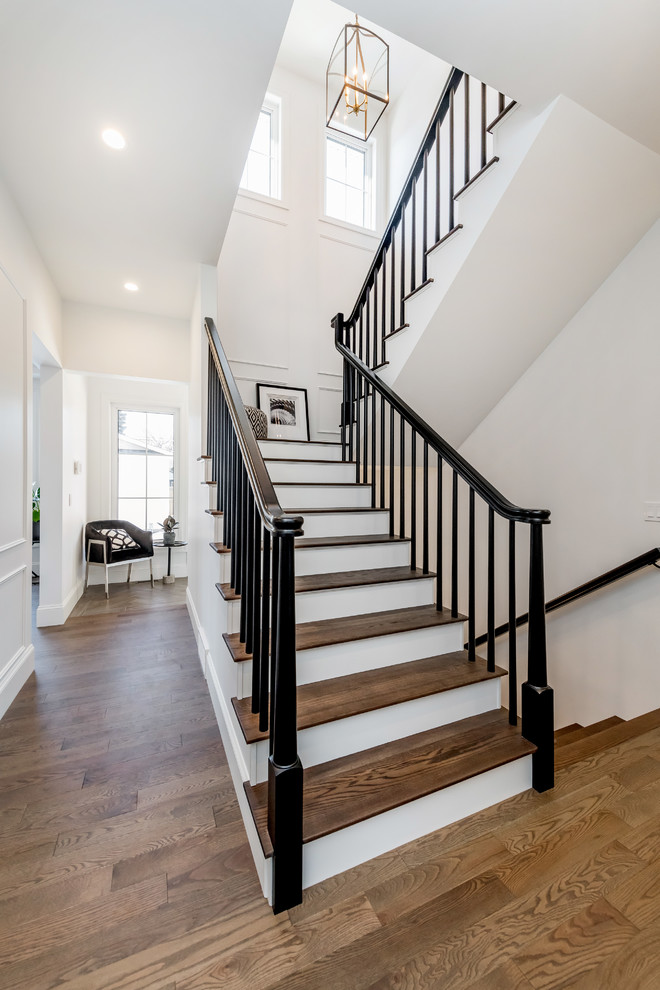 Design ideas for a large transitional wood u-shaped staircase in Other with painted wood risers and wood railing.
