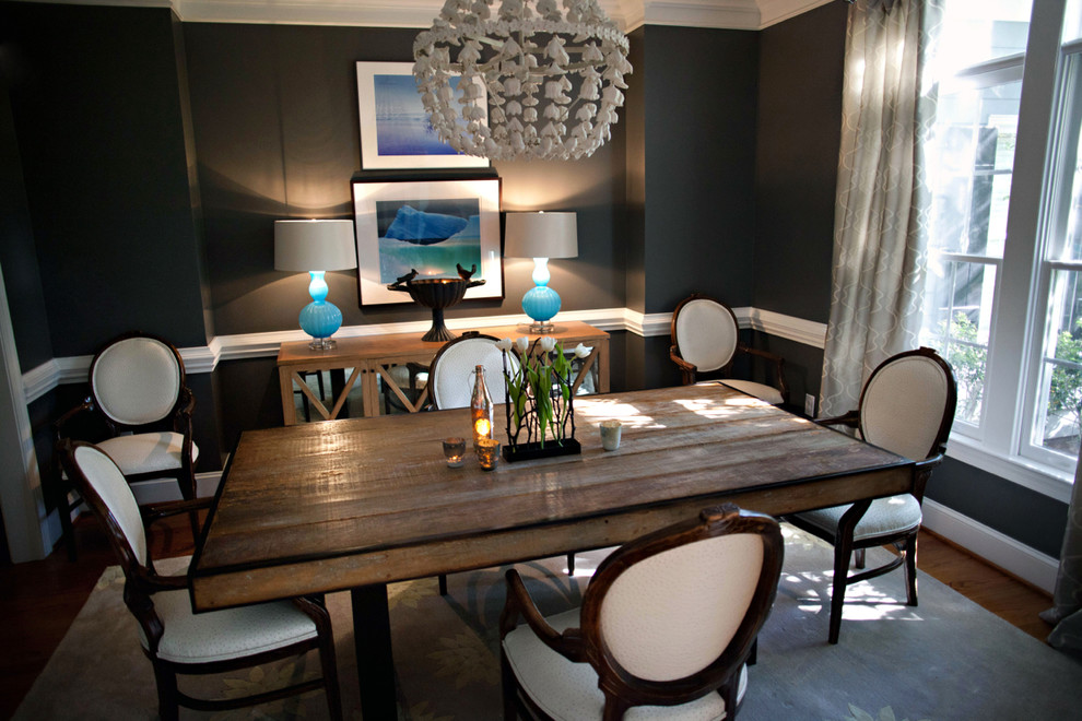 Inspiration for a traditional separate dining room in Raleigh with black walls and medium hardwood floors.