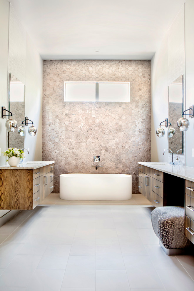 This is an example of a contemporary master bathroom in Austin with flat-panel cabinets, dark wood cabinets, a freestanding tub, beige tile, beige walls, an undermount sink, beige floor, cement tile, porcelain floors and marble benchtops.