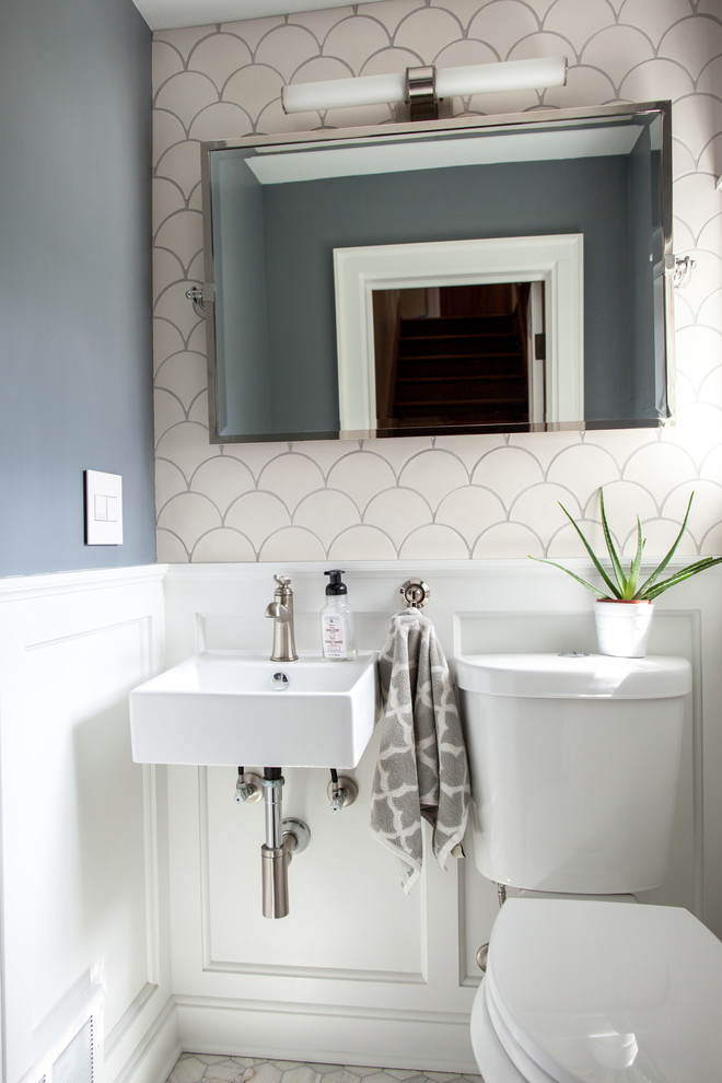 Photo of a small modern 3/4 bathroom in Minneapolis with a two-piece toilet, white tile, ceramic tile, grey walls, marble floors, a wall-mount sink and white cabinets.