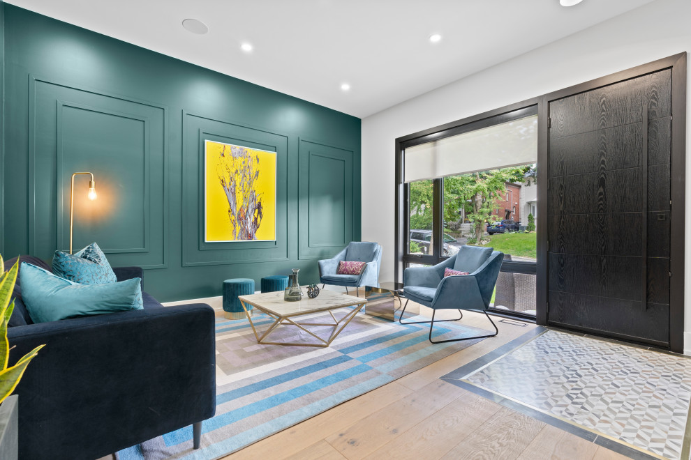 This is an example of a mid-sized contemporary open concept living room in Toronto with green walls, green floor and decorative wall panelling.