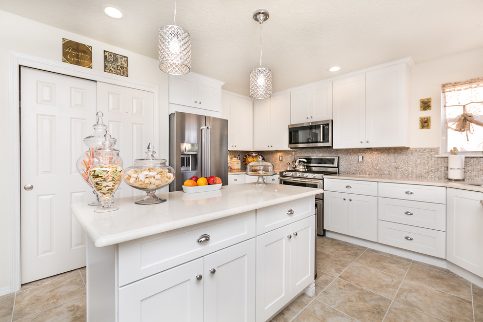 Mid-sized transitional u-shaped separate kitchen in Albuquerque with a single-bowl sink, shaker cabinets, white cabinets, quartz benchtops, multi-coloured splashback, glass tile splashback, stainless steel appliances, porcelain floors and with island.