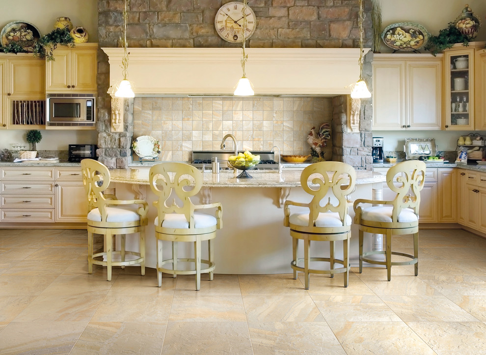 Country l-shaped kitchen in San Francisco with raised-panel cabinets, beige cabinets, beige splashback, with island, beige floor and beige benchtop.