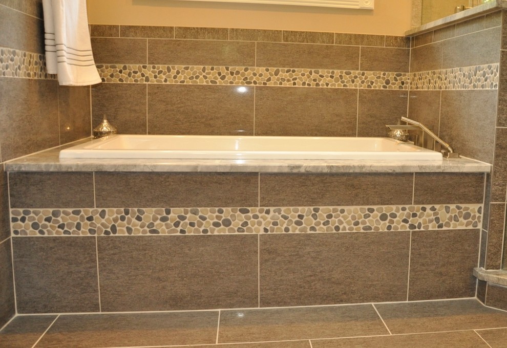 Transitional master gray tile and porcelain tile porcelain tile drop-in bathtub photo in Cincinnati with granite countertops and beige walls