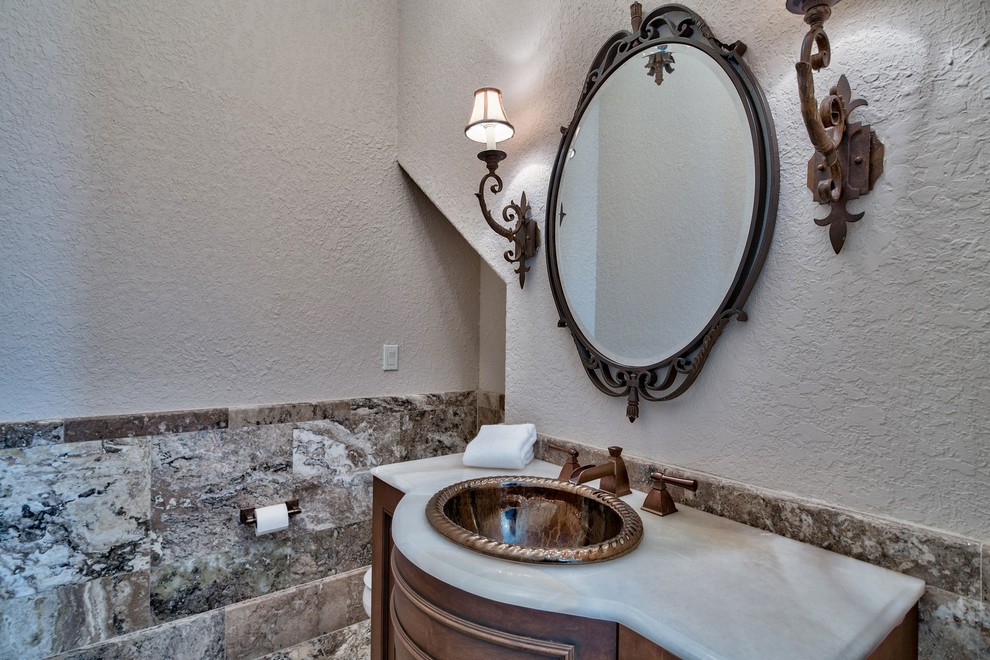 This is an example of a mediterranean powder room in Miami.