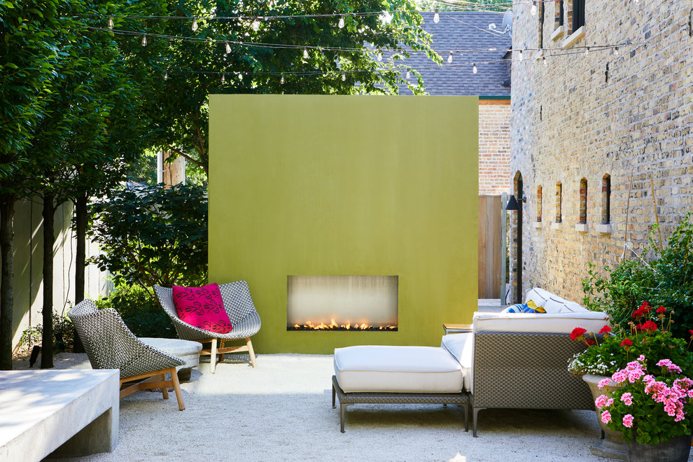 Trendy courtyard gravel patio photo in Chicago with no cover and a fireplace
