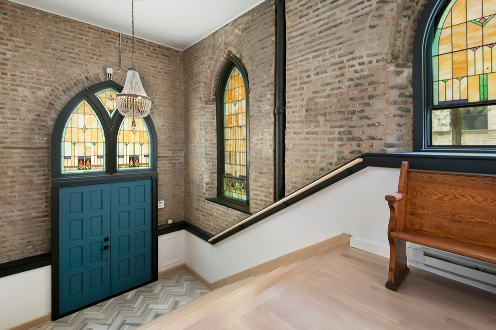 Traditional entryway in Chicago with light hardwood floors, a double front door, a blue front door and grey floor.