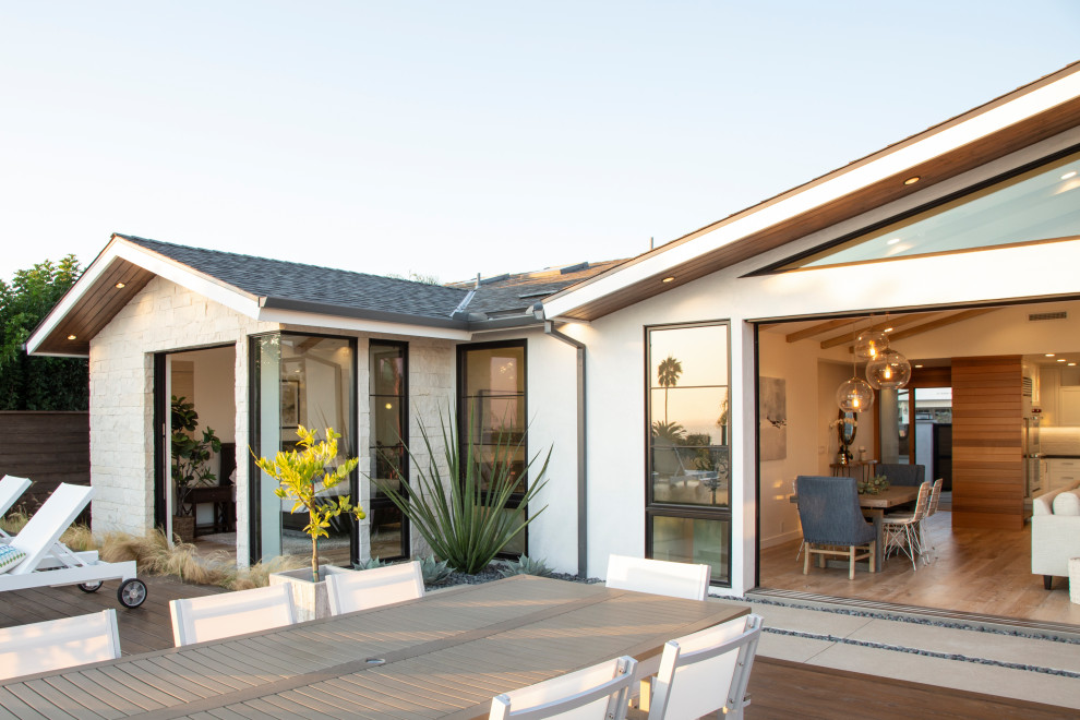 Inspiration for a transitional backyard deck remodel in Orange County with a fire pit