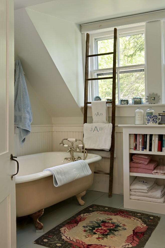 Inspiration for a traditional bathroom in Burlington with open cabinets and a claw-foot tub.