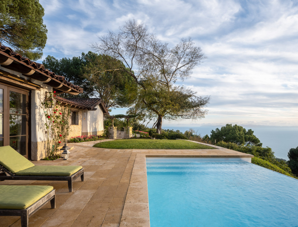 Pool - mid-sized rustic front yard stone and custom-shaped infinity pool idea in Los Angeles