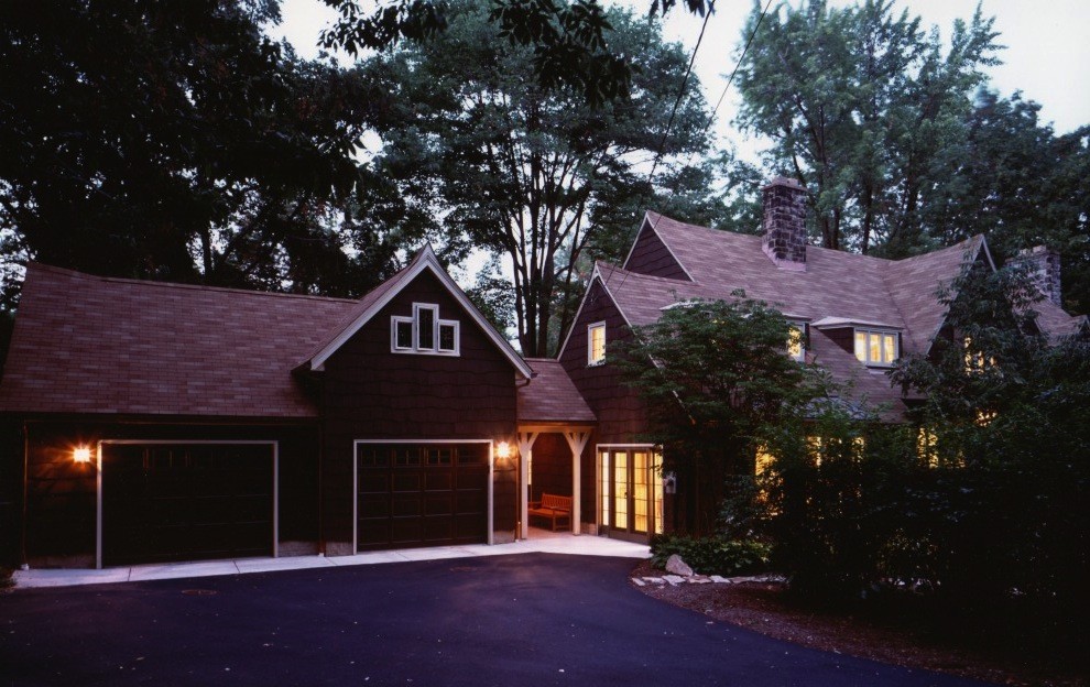 Inspiration for a large traditional two-storey brown exterior in Cleveland with stone veneer and a clipped gable roof.