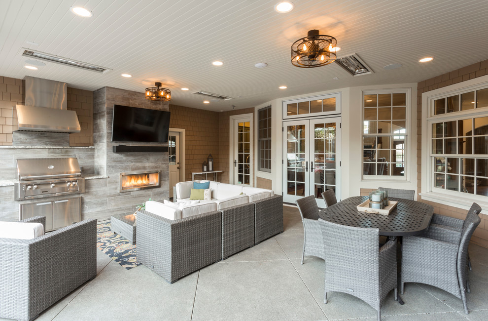 Example of a huge transitional backyard concrete patio kitchen design in Portland with a roof extension